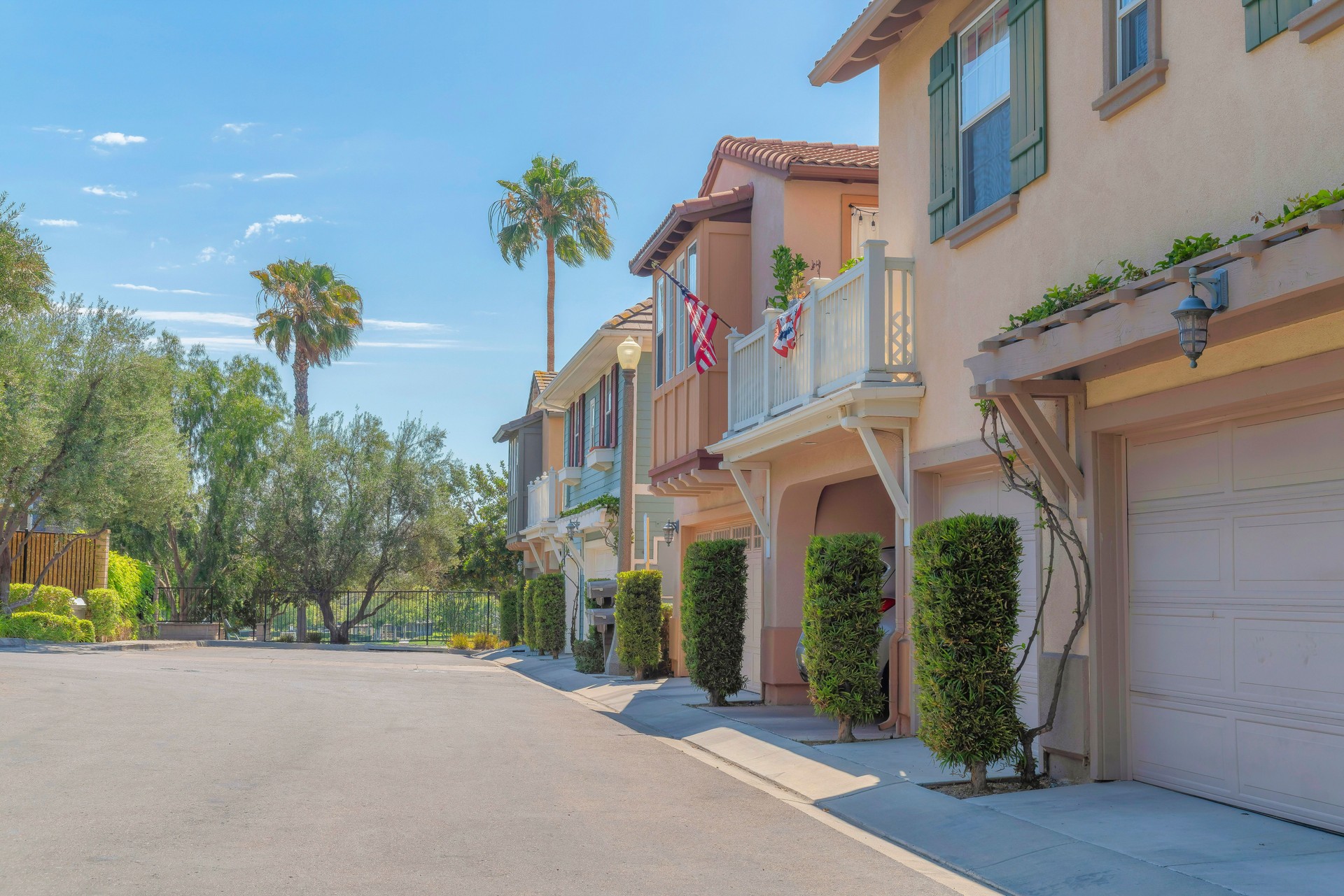 Neighborhood houses with topiary shrubs at the front of the garage doors at Ladera Ranch, California